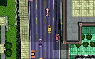 Top-down view of the original Grand Theft Auto, showing cars on an avenue beside buildings and trees