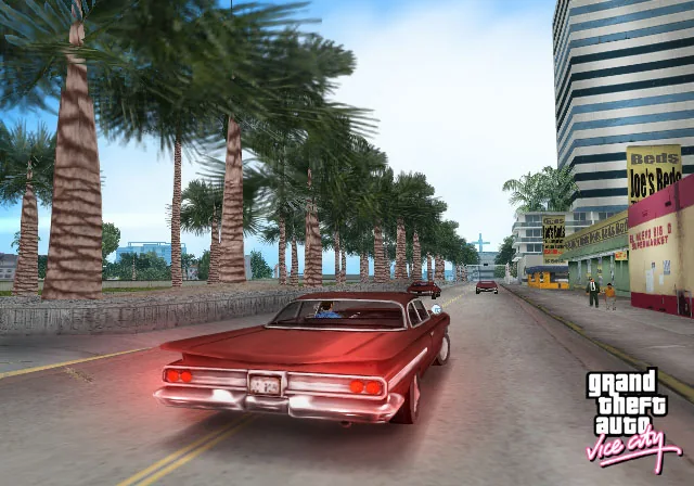 A red car drives along a palm-lined seafront avenue in GTA Vice City